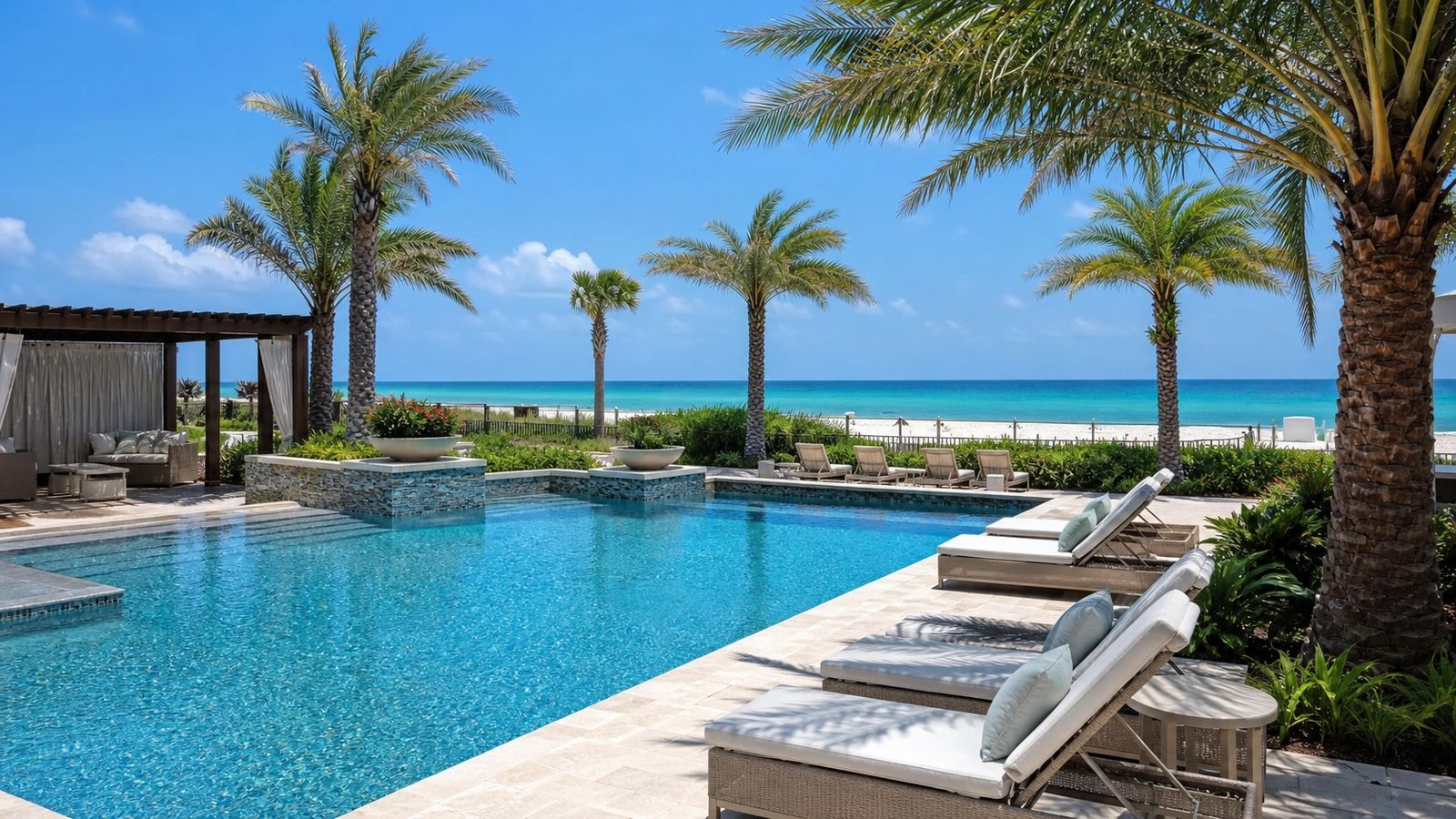 Upscale resort pool area near the Gulf of Mexico in Destin Florida with palm trees and lounge chairs