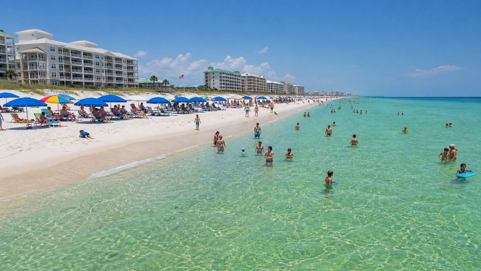 Destin Florida beach scene with white sand, colorful umbrellas, families wading in emerald Gulf water on a sunny summer day