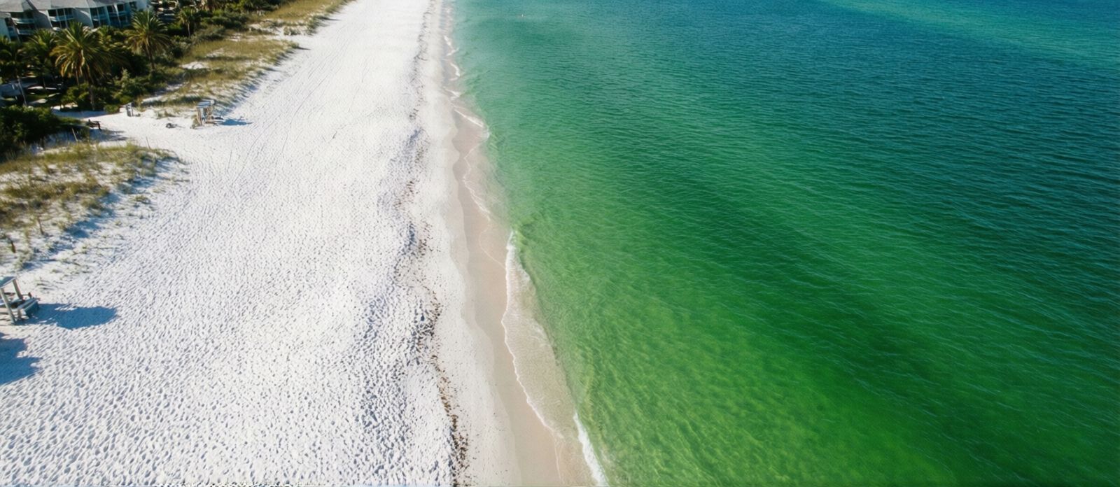 Aerial view of Destin Florida beach with sugar-white sand and brilliantly emerald-green Gulf water that rivals tropical destinations