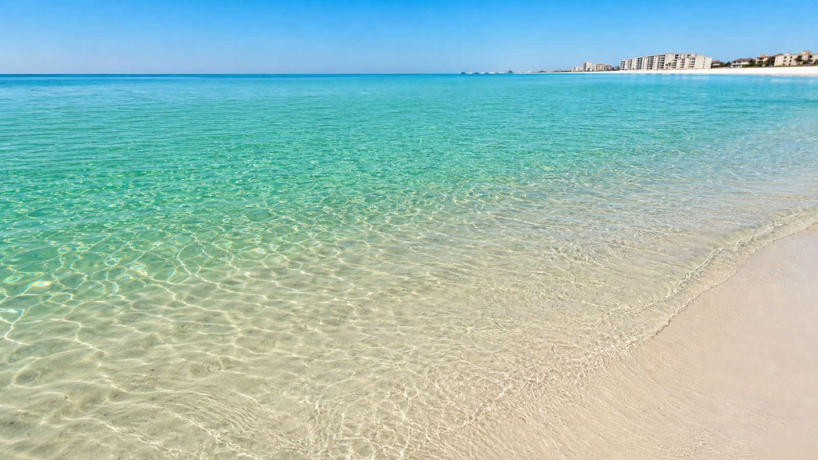 Crystal-clear emerald Gulf water looking down at white sandy bottom in Destin Florida