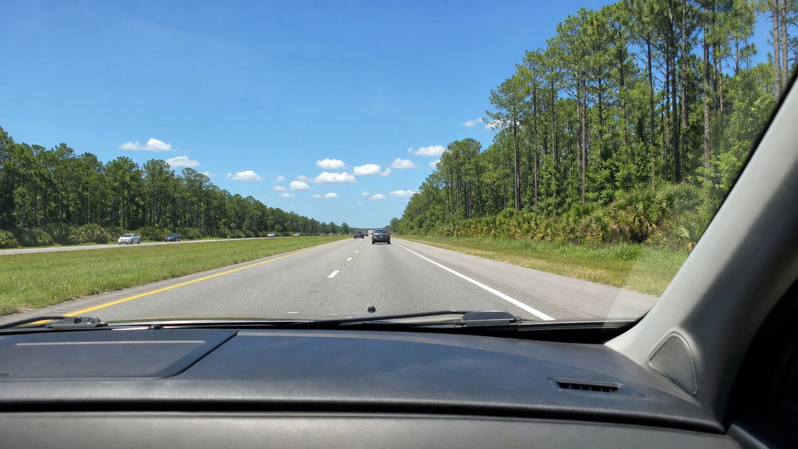 Highway road trip view heading south through the American Southeast toward a Gulf Coast beach vacation