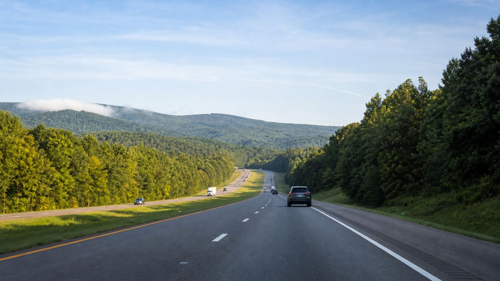 I-59 South interstate highway through forested northeast Alabama hills on a clear summer morning heading toward the Florida Panhandle