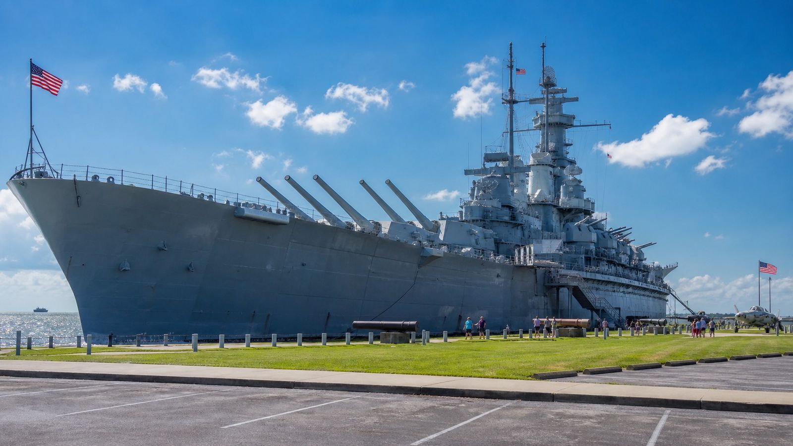USS Alabama WWII battleship memorial park in Mobile Alabama with the massive gray battleship and Mobile Bay on a sunny summer afternoon