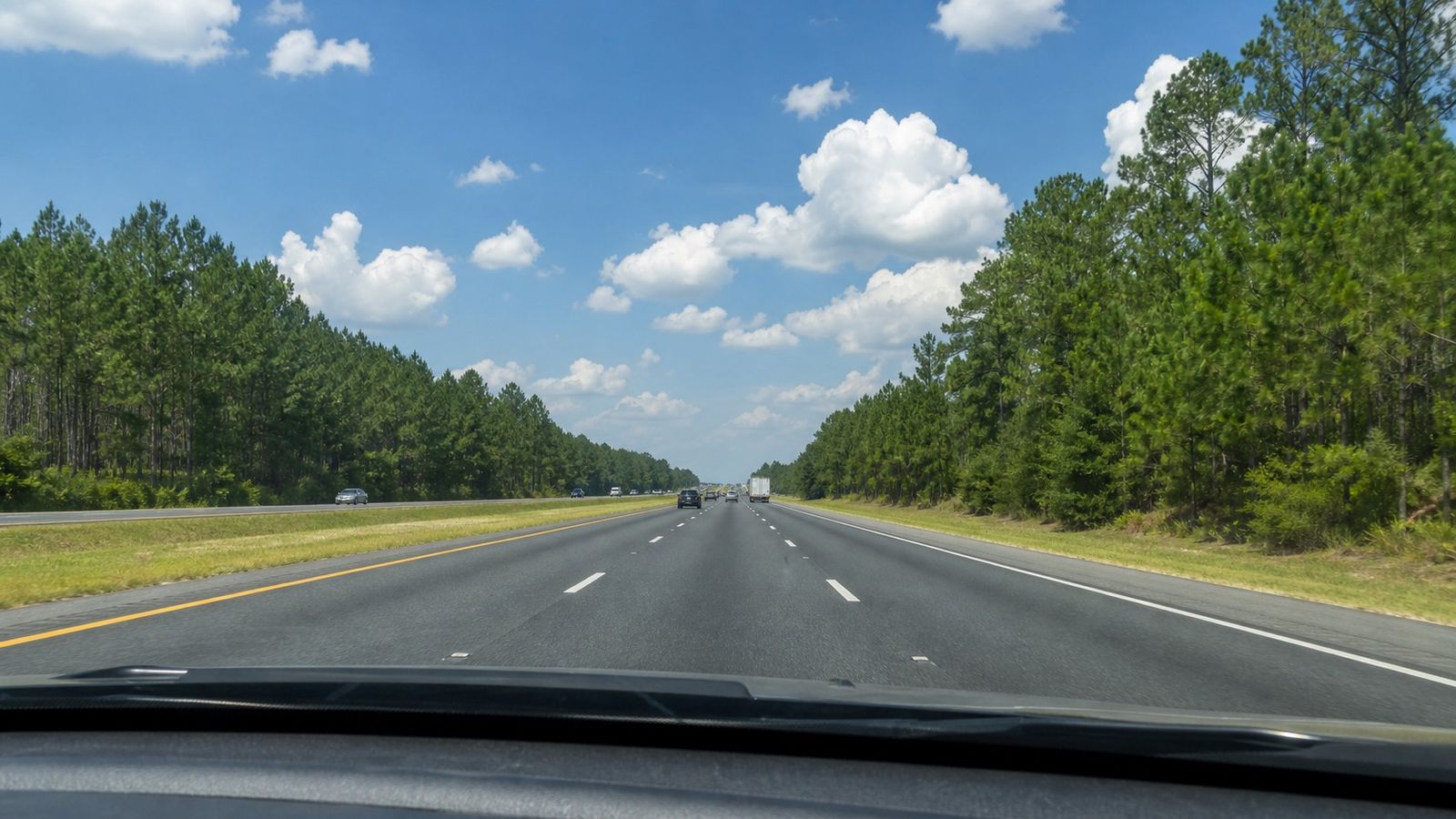View from inside a car on I-10 East through southern Alabama heading toward Pensacola and Destin on a summer morning