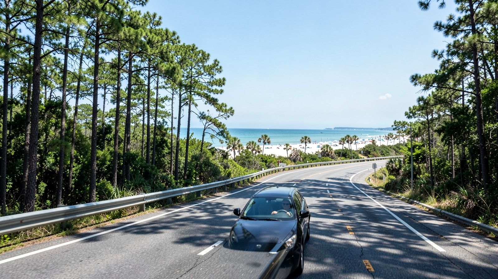 Four-lane interstate highway through lush green pine forests in the Southeast, typical scenery on the Norfolk to Destin drive