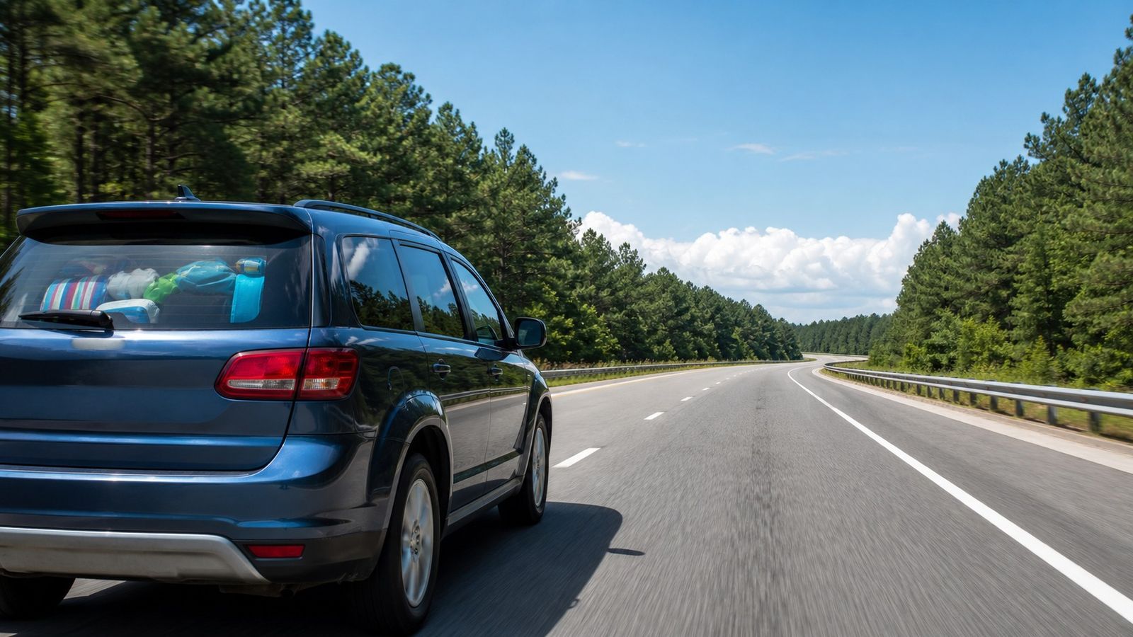 Family SUV loaded with beach gear driving south on a southeastern US interstate highway