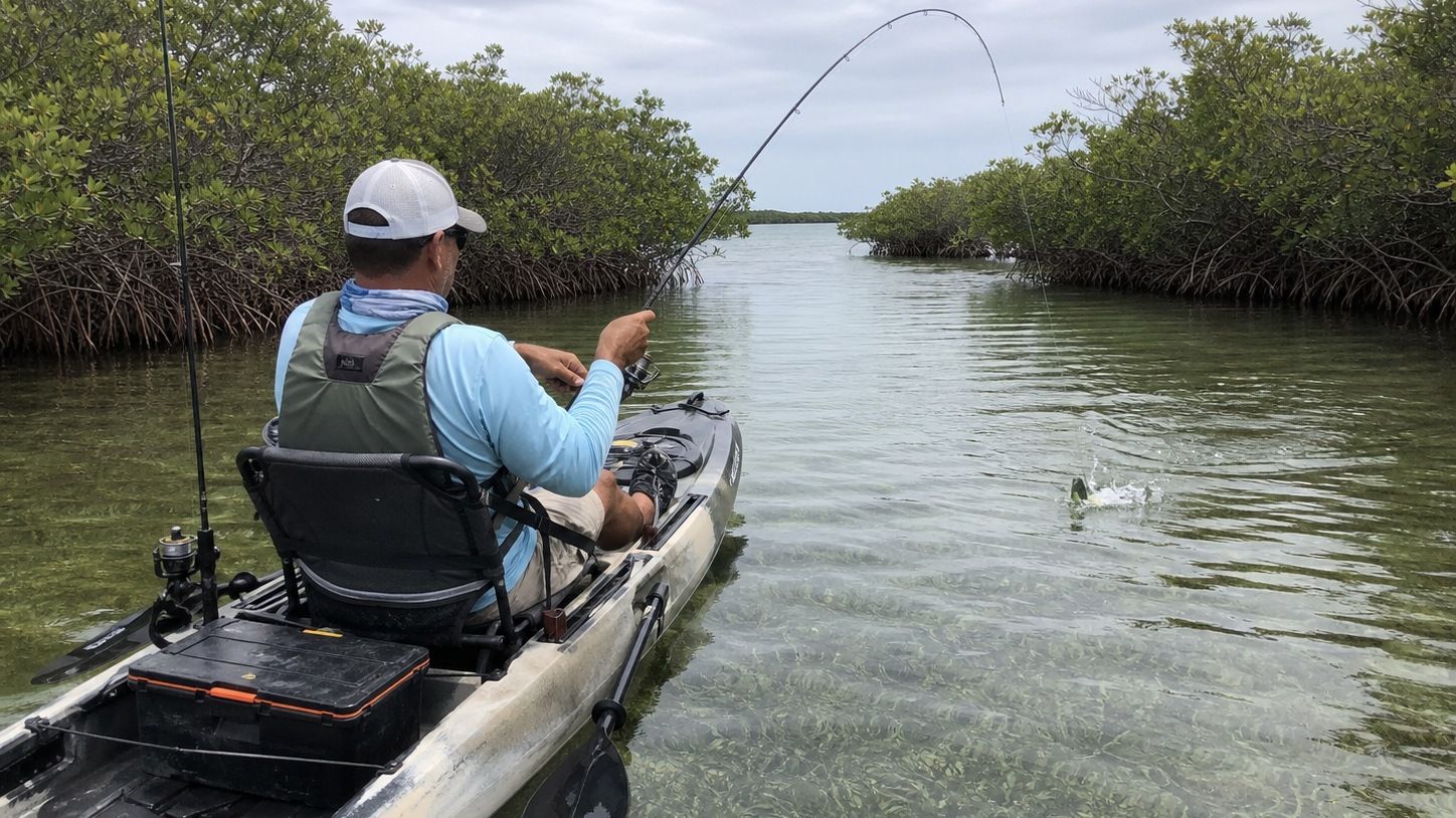 Angler fishing from a kayak in a shallow tidal creek near Destin Florida