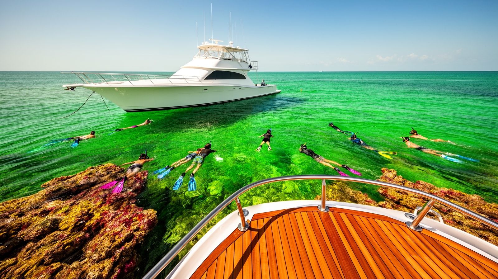 Snorkel charter boat anchored over a reef in the Gulf near Destin Florida with snorkelers in the water on a clear summer day